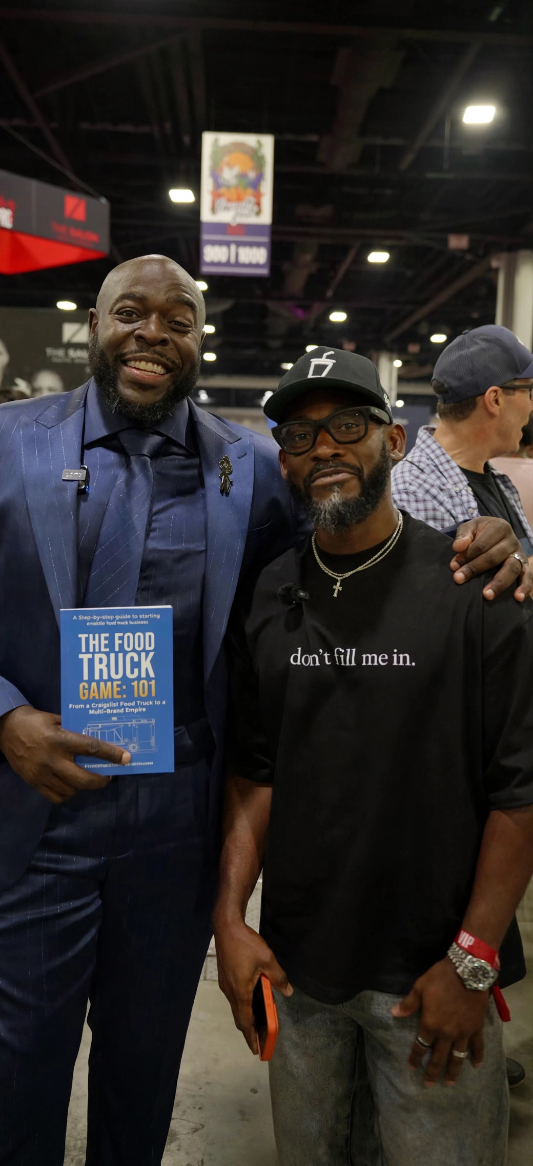 Marcus Lemonis holding The Food Truck Game: 101 with Bossman Daryl