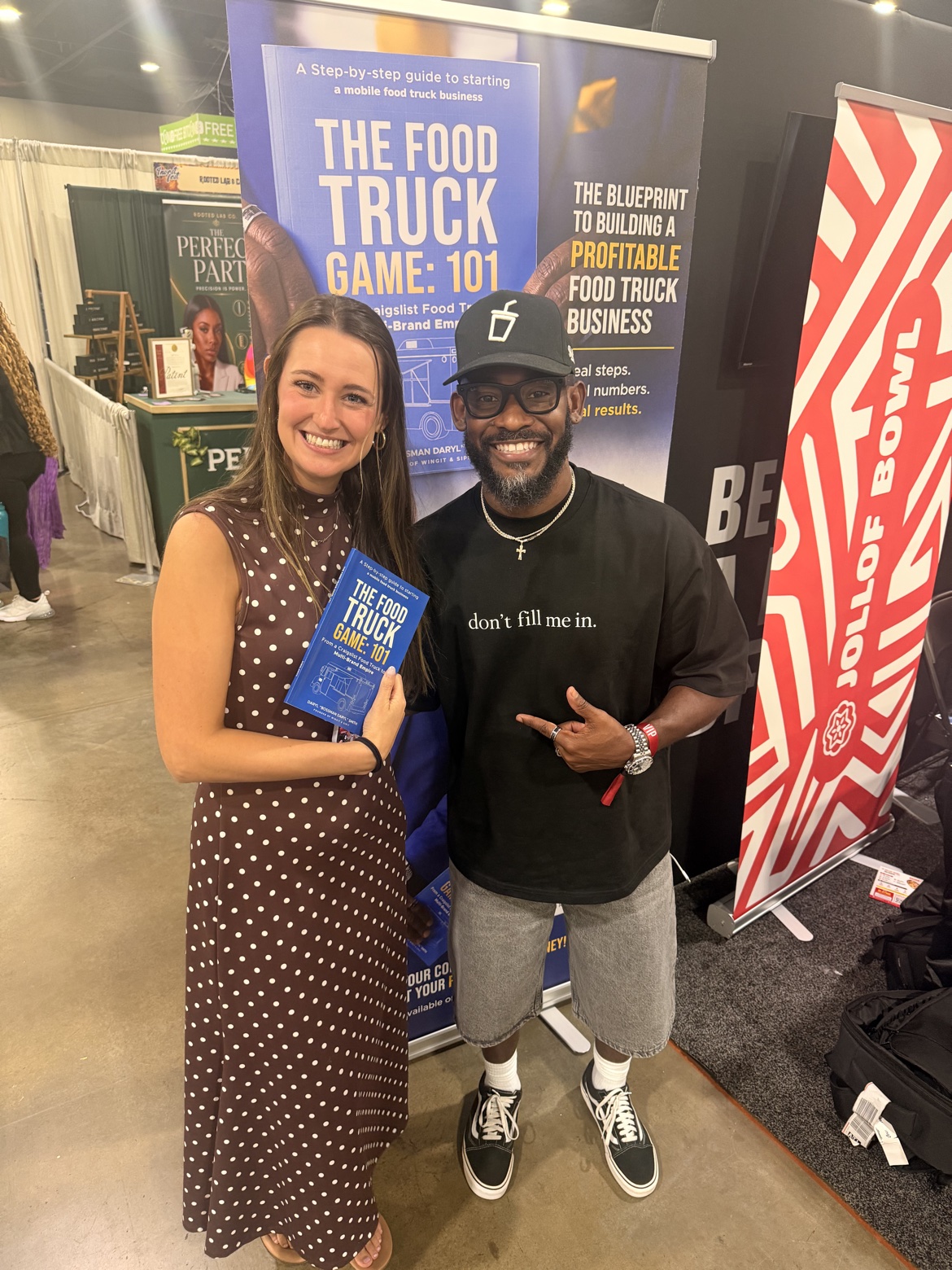 Reader holding The Food Truck Game: 101 with Bossman Daryl at a book expo